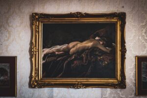 brown wooden framed painting of woman and man