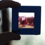person holding square black photo frame